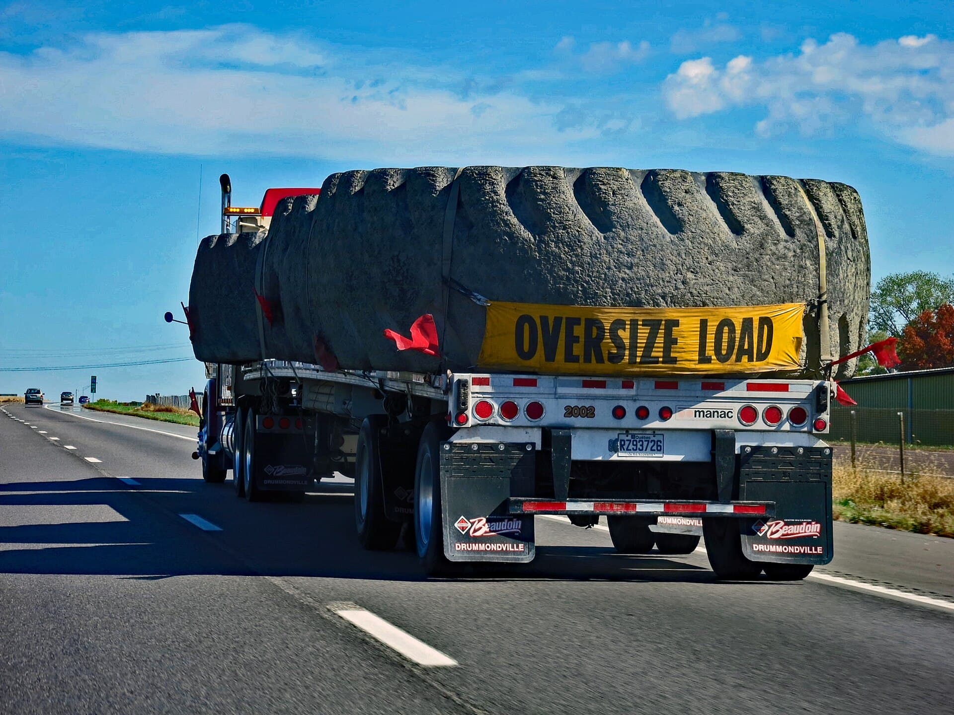 A giant off-the-road mining tyre transported on a flatbed truck